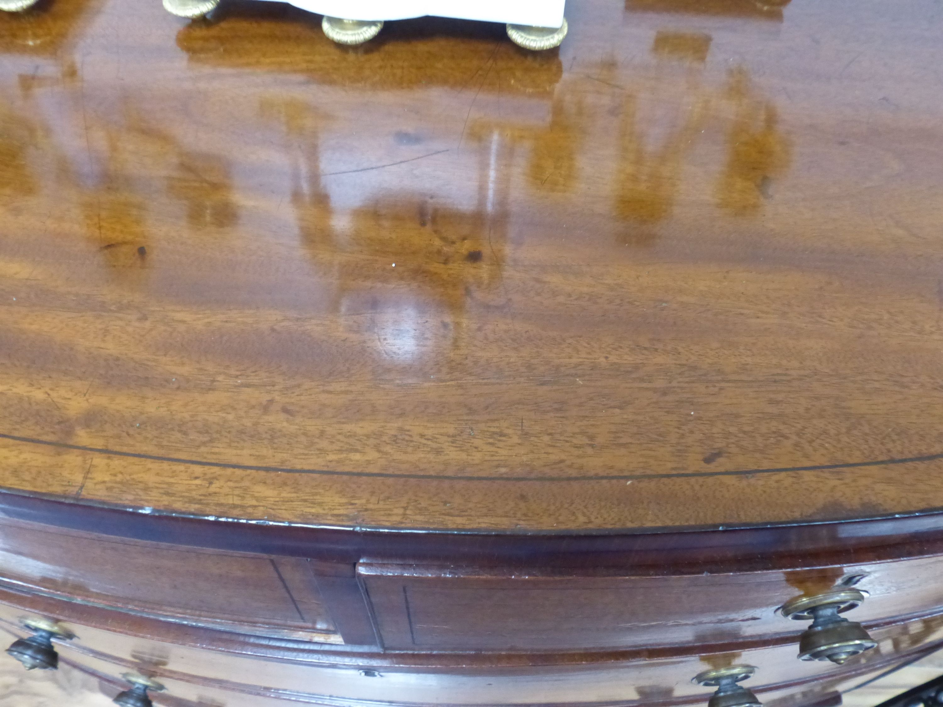 An early 19th century bow fronted mahogany chest, width 91cm, depth 50cm, height 97cm